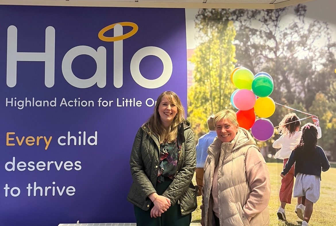 Emma Roddick with HALO founder in front of the charity’s colourful “Every child deserves to thrive” wall display.